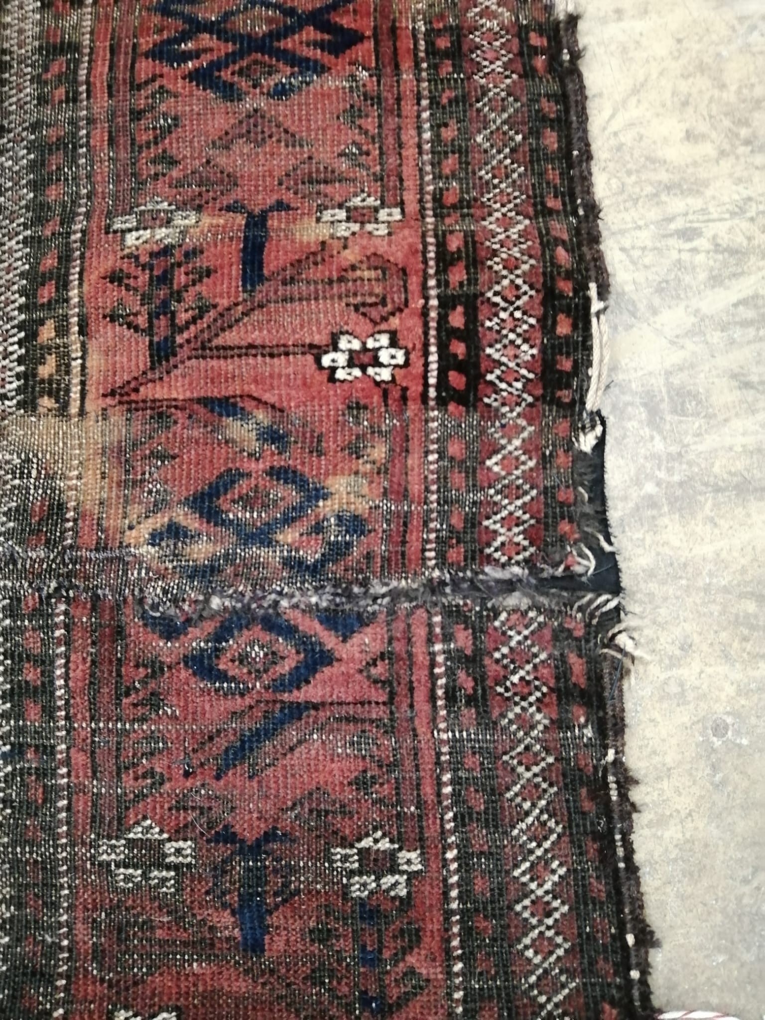 An antique Belouch red rug, 140 x 100cm